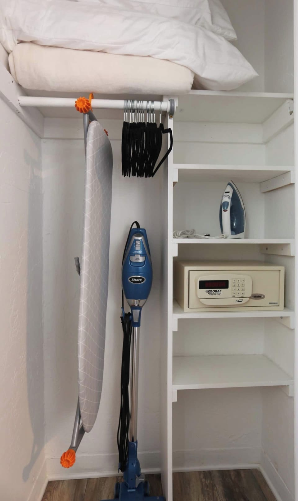 King Bedroom Closet with Iron & Ironing Board, Safe, Clothes Hangers, hotel style safe for your valuables, extra blanket, stick vacuum for your convenience.