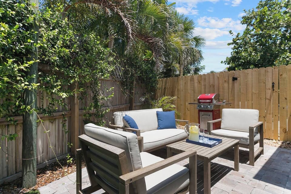 217 Fenced yard with conversation seating for 4, cold water shower, bar-b-que grill, brick paver patio and turf .  Interconnecting gate between units.