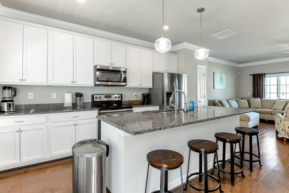 Well stocked kitchen with island seating. 