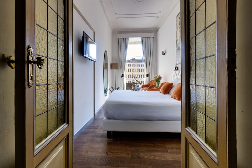 Deluxe Suite, Balcony, City View | Minibar, in-room safe, desk, soundproofing