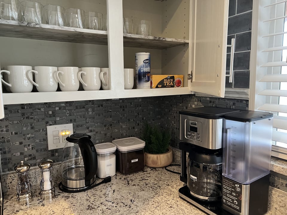 Coffee station, coffee mugs and drinking glasses