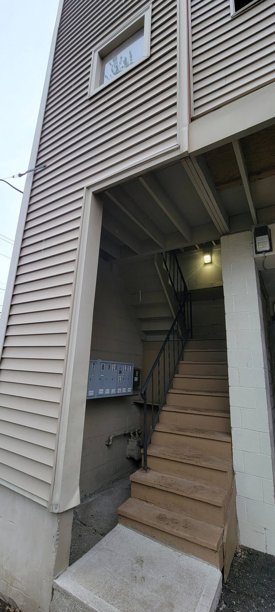 Staircase next to carport,  leads to entry hall.