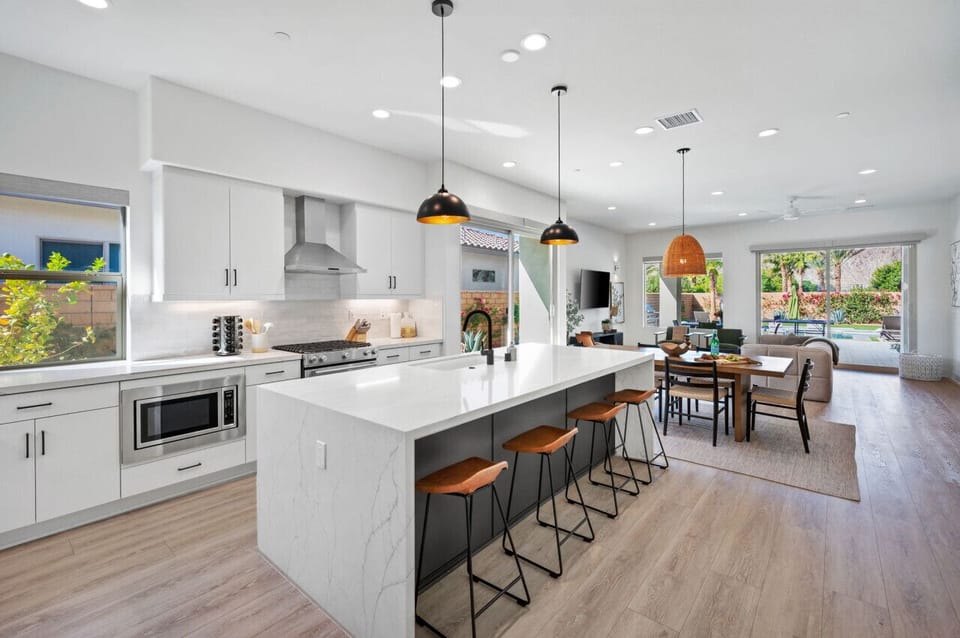 Sleek kitchen w/ large island & bar seating, ideal for casual dining
