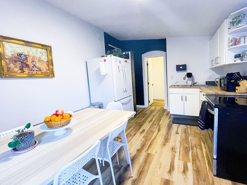 Kitchen table + electric stove and plenty of counter space.