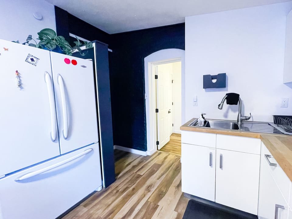 Kitchen with full fridge.