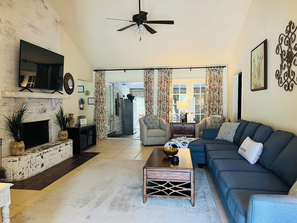 Large living room with extra seating for viewing, relaxation, and conversation