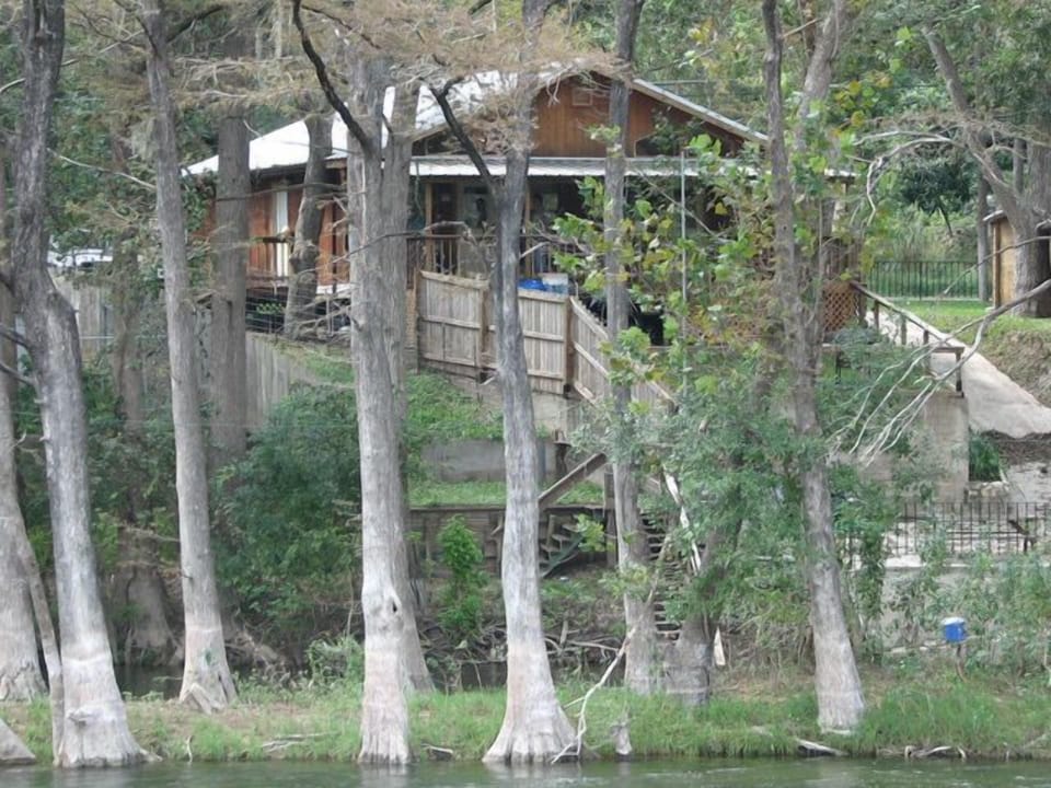 View of cabin from across the river