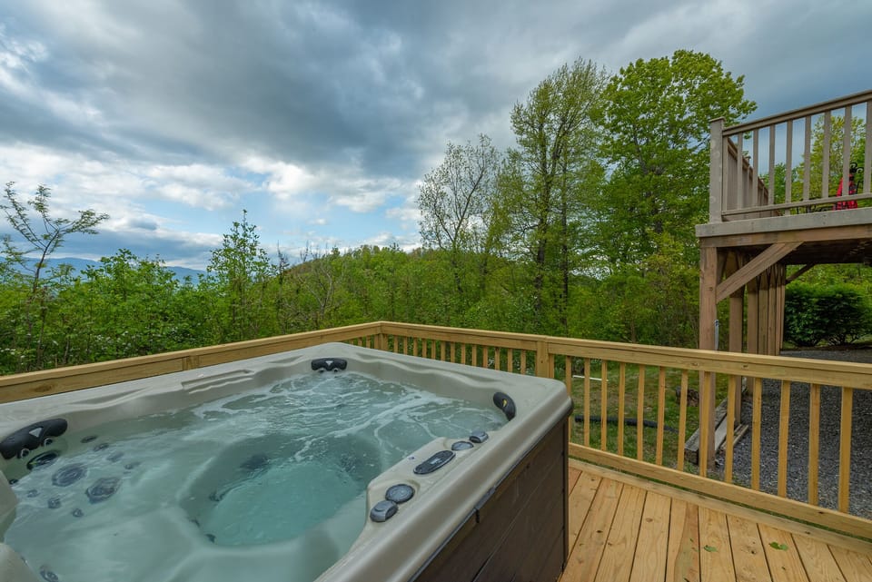 Relax & enjoy mountain views in the newly-added hot tub with a glass of wine.