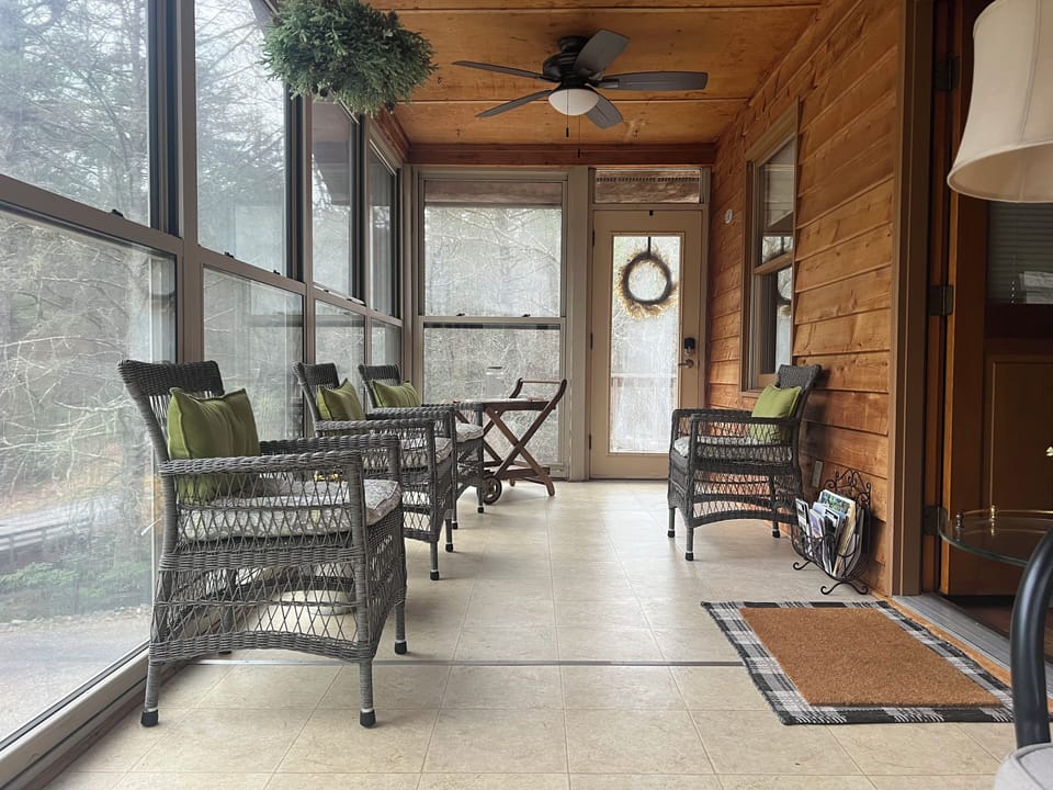 The sunroom opens to the wrap around deck 