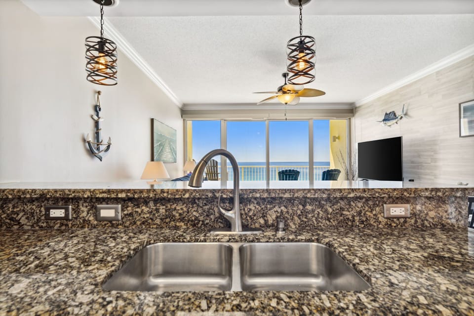 The fully equipped kitchen features granite countertops and stainless-steel appliances.