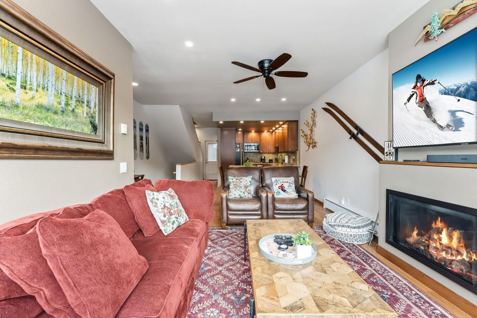 Cozy up by your crackling fireplace after mountain adventures, with plush seating and an open kitchen perfect for sharing stories.