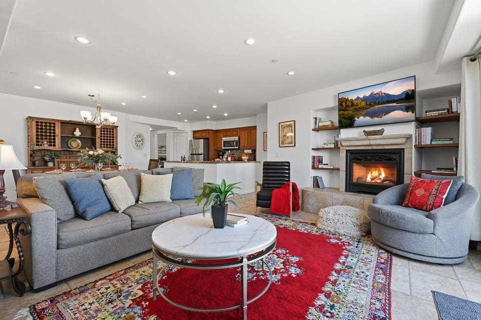 Relax in your spacious living room with cozy fireplace, stylish furnishings, and open-concept design perfect for gathering.