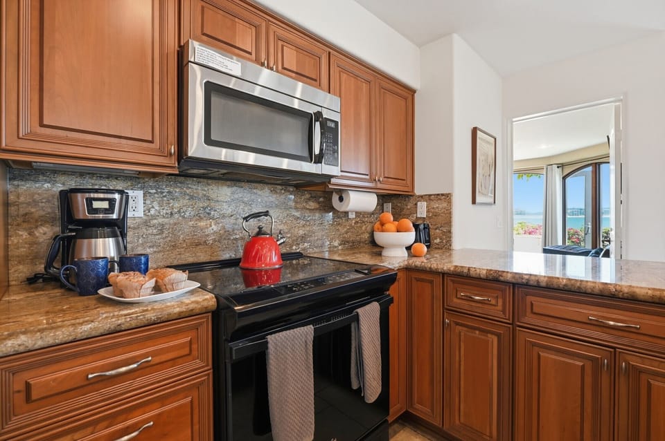 Your fully equipped kitchen awaits with granite countertops, modern appliances, and coffee ready for your perfect vacation mornings.