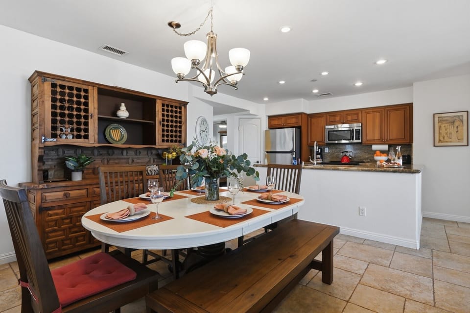 Gather around your elegant dining table for memorable meals, with a fully equipped kitchen and charming wine storage nearby.