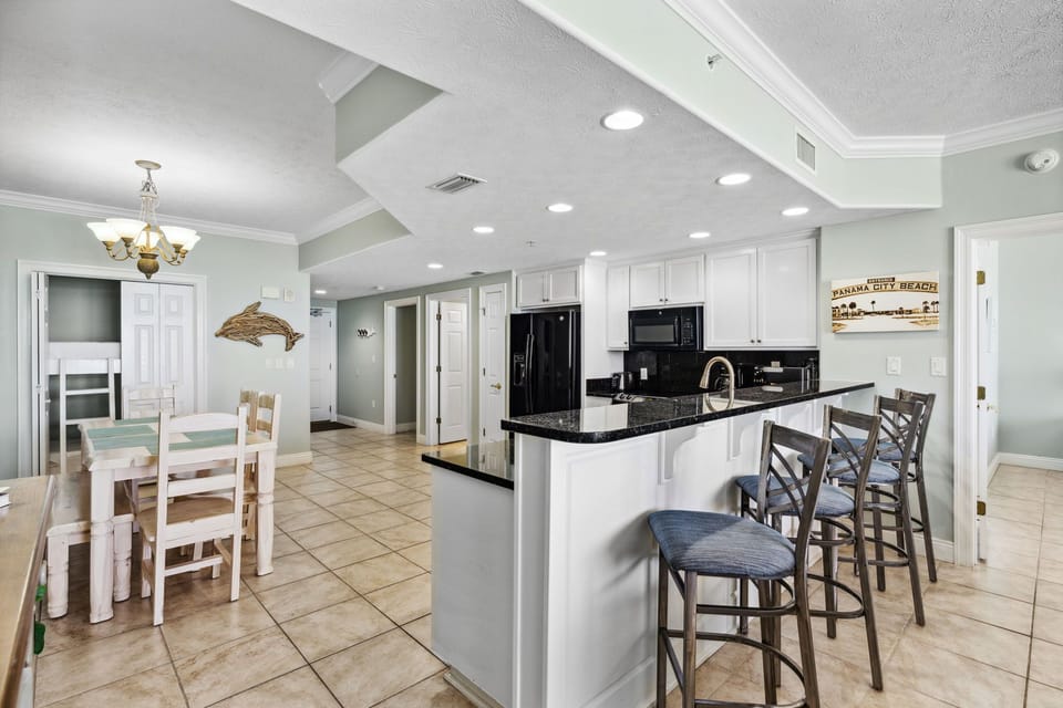 Spacious kitchen w/ bar seating, perfect for casual meals & morning coffee
