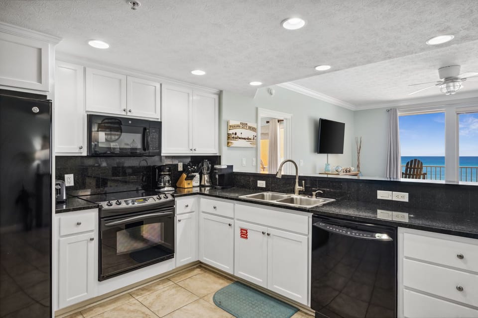Bright kitchen w/ stainless appliances & plenty of counter space for easy meal prep
