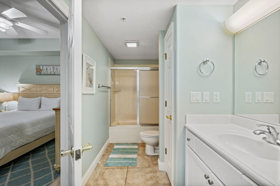 Fresh guest bathroom w/ a spacious vanity & shower-tub combo for daily routines