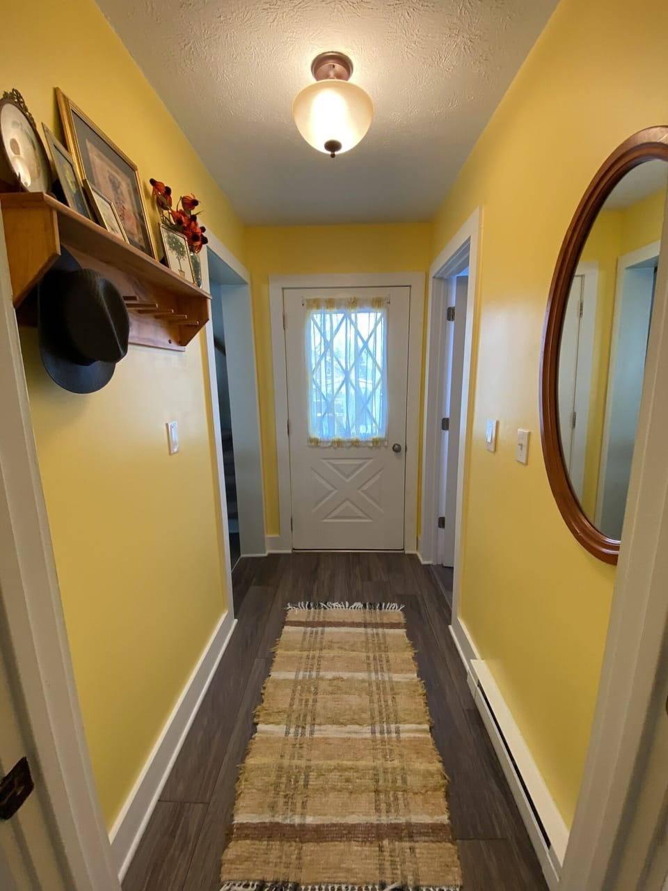 This cheery hallway takes you to the door to the back yard or the master bedroom