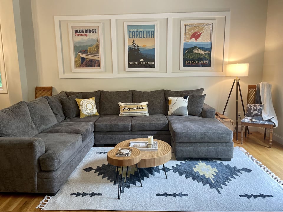 cozy couch on main floor with TV and fireplace