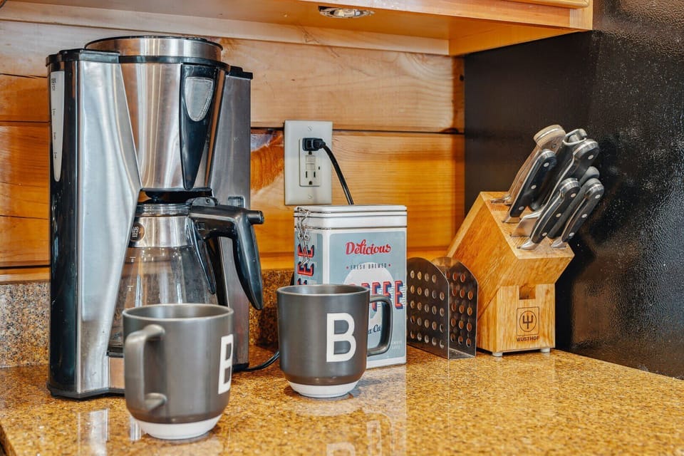 Coffee station with drip brewer, mugs, and
    knife set — fully stocked for
    cooking in
