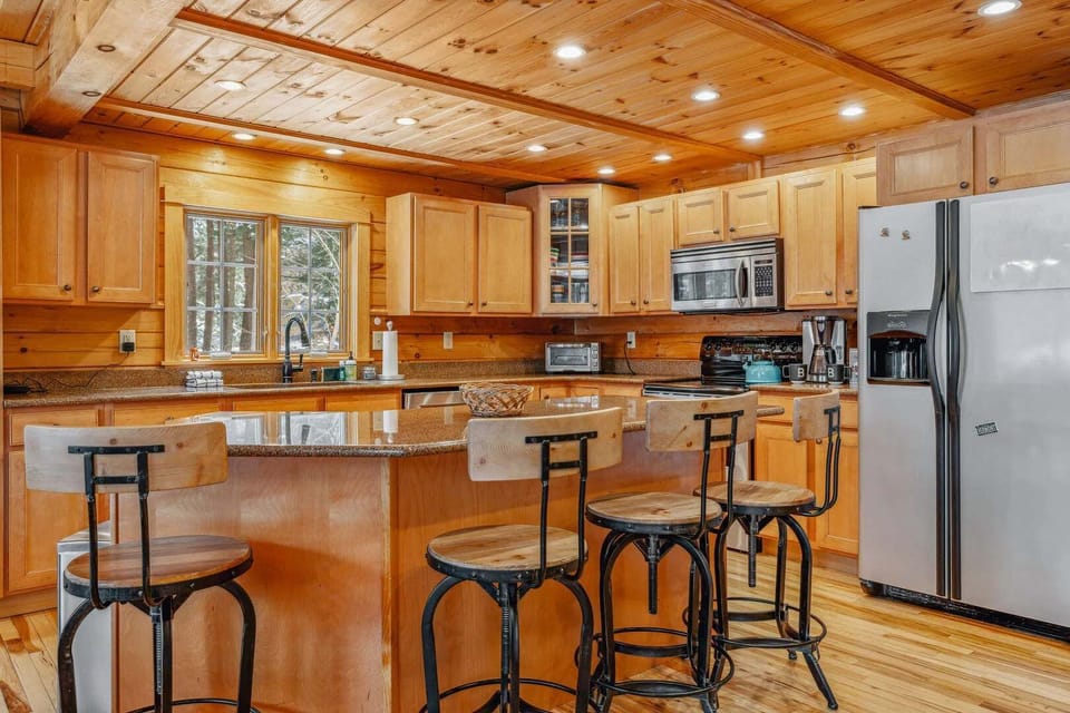 Fully equipped kitchen with granite island
    seating, gas range, and stainless appliances