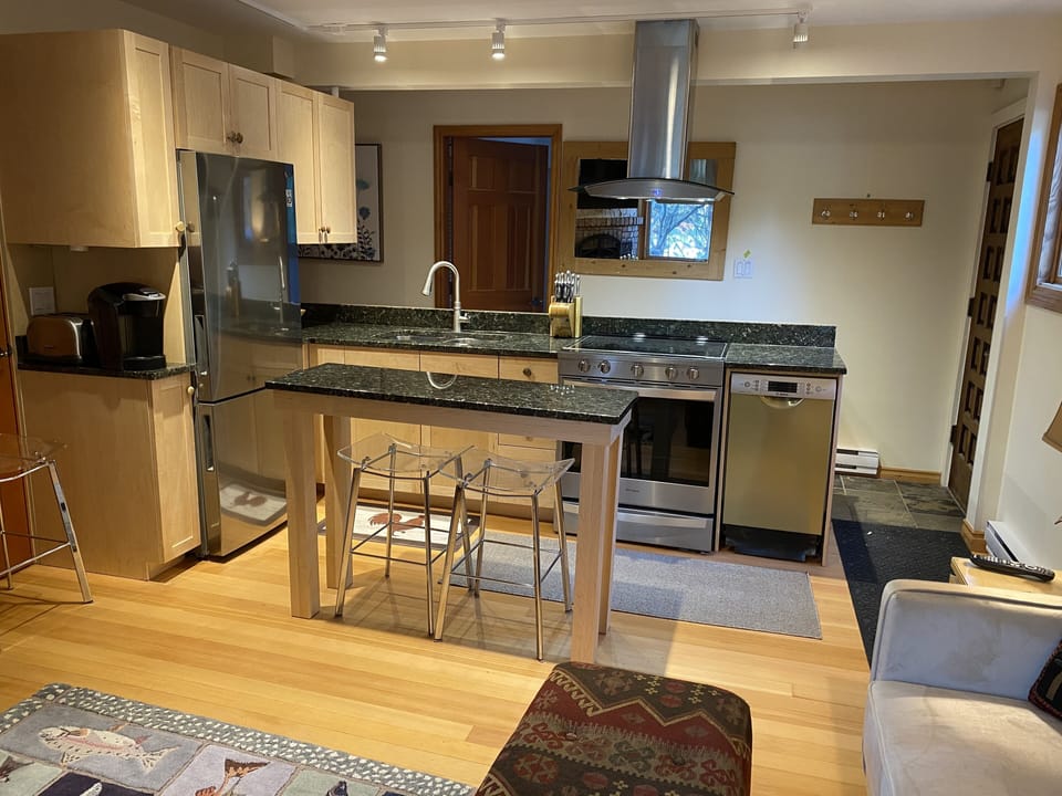 new kitchen with granite counter tops, new appliances, island table