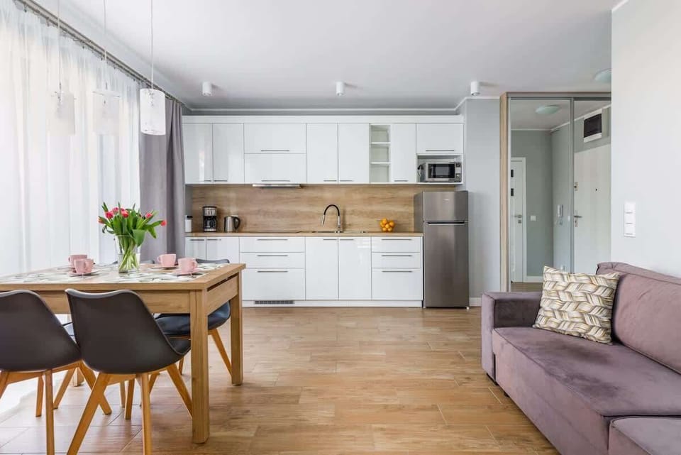 Living room with a dining table with chairs for four people.