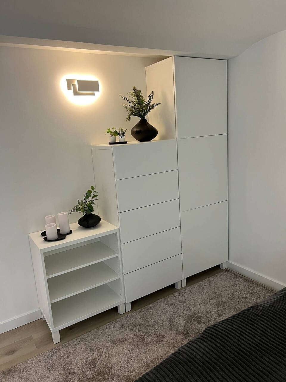 Mezzanine. Minimal furniture, greenery, soft light. A calm corner.