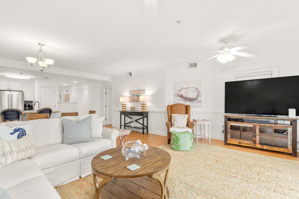 The living area with a sleep sofa and large flat-screen TV