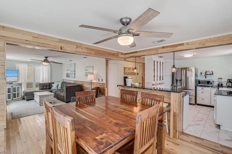 Open-concept layout connecting kitchen, dining, and living spaces.