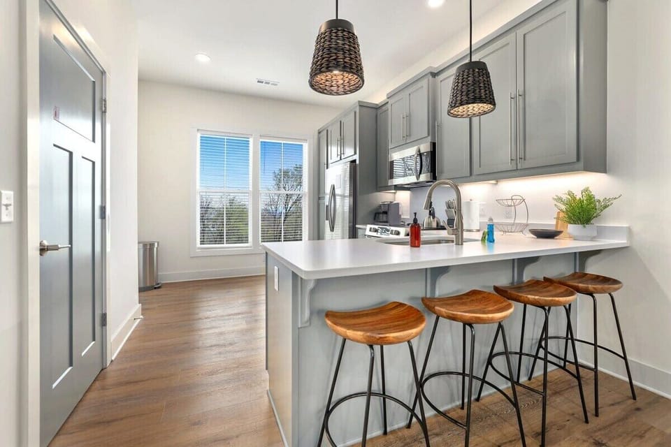 Between the kitchen and the living room, you'll find four barstools overlooking the kitchen.