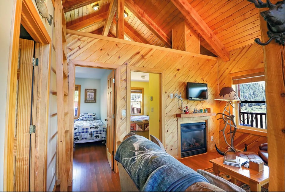 Living room with a view of loft space. Access to loft via step ladder.