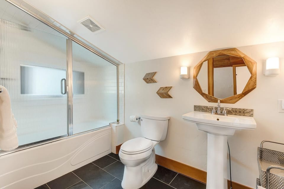 The charming ensuite bath with tub/shower entry for a 6ft person.