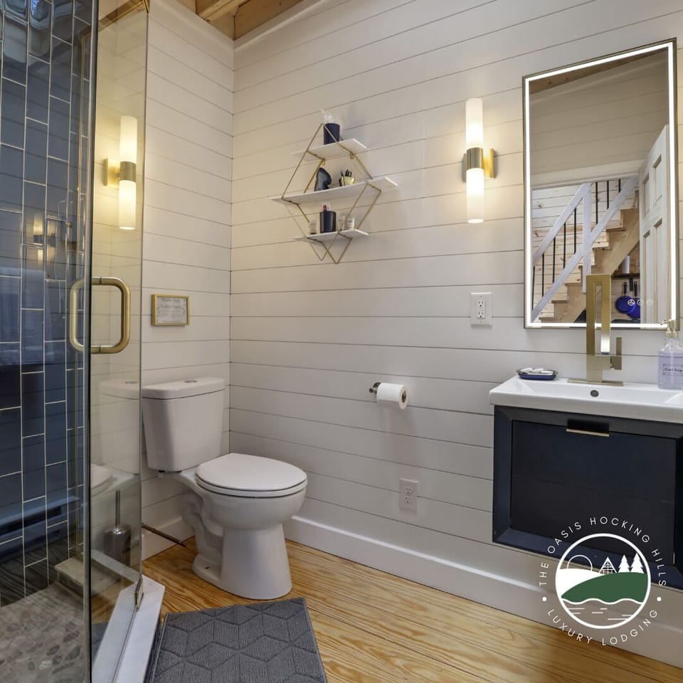 Bathroom with digital mirror and gold accents. 