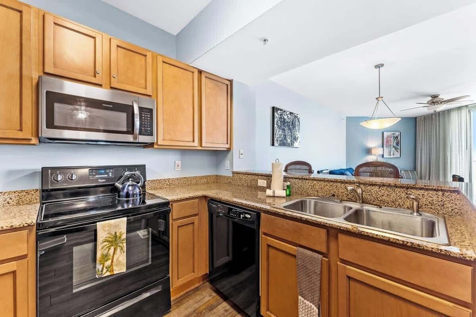 Kitchen with flat top stove and cleaning supplies
