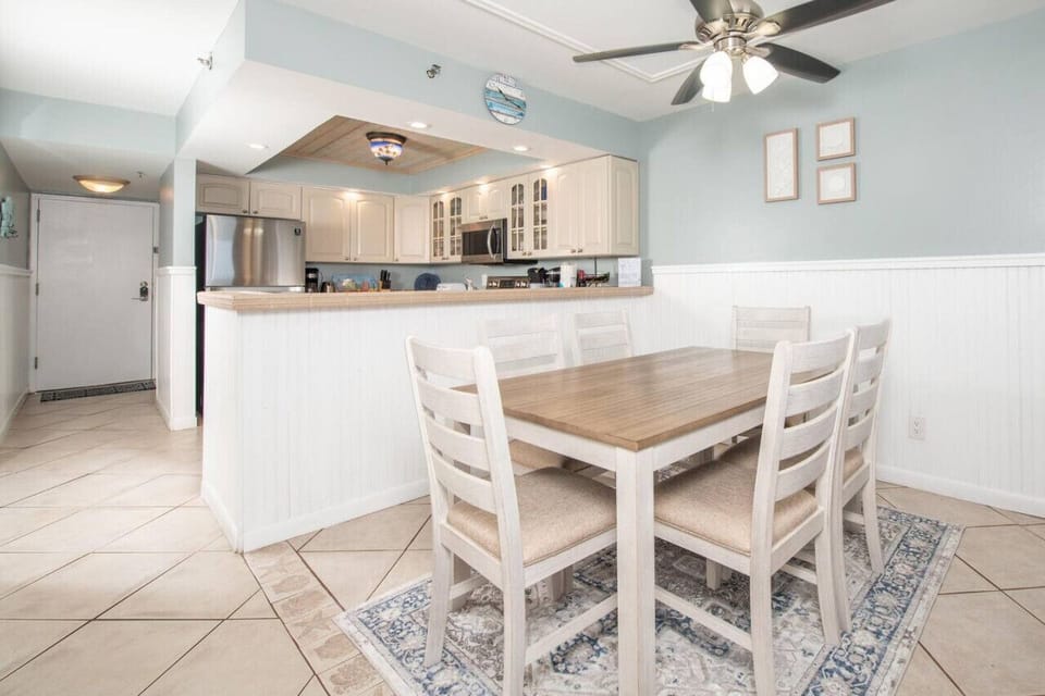 Open dining area w/ white finishes that flows easily into the kitchen for shared meals & conversation.