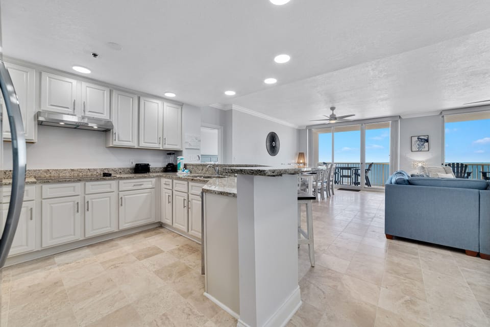 This fully functional kitchen boasts stainless steel appliances, sleek countertops, and ample cabinet storage, ideal for everyday cooking and entertaining.