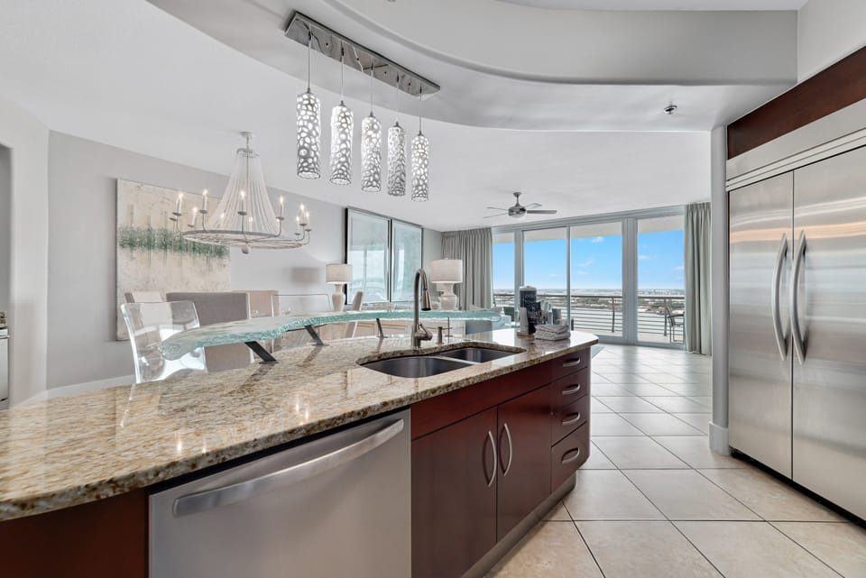 Imagine preparing delicious meals with ease in this well-appointed kitchen, all while staying connected with family and friends in the adjacent living and dining areas. This open-concept design is ideal for a relaxed coastal lifestyle.