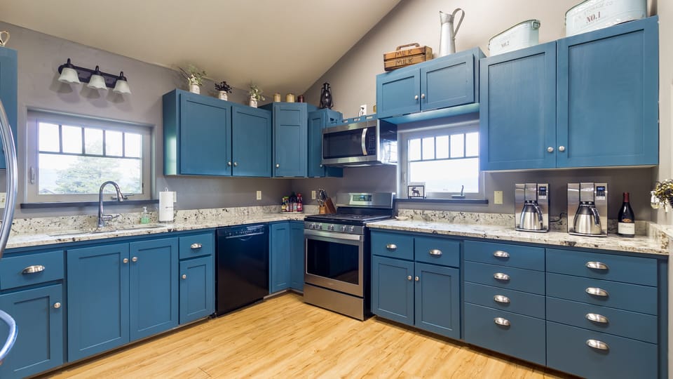 This property's fully equipped and spacious kitchen is a cook's dream come true. You can prepare delicious home-cooked meals with ample counter space and all the necessary cookware and appliances. It is the perfect space for all your culinary needs.