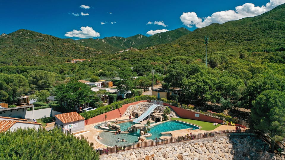 Beautifully landscaped pool area nestled in nature, providing a serene and refreshing escape.