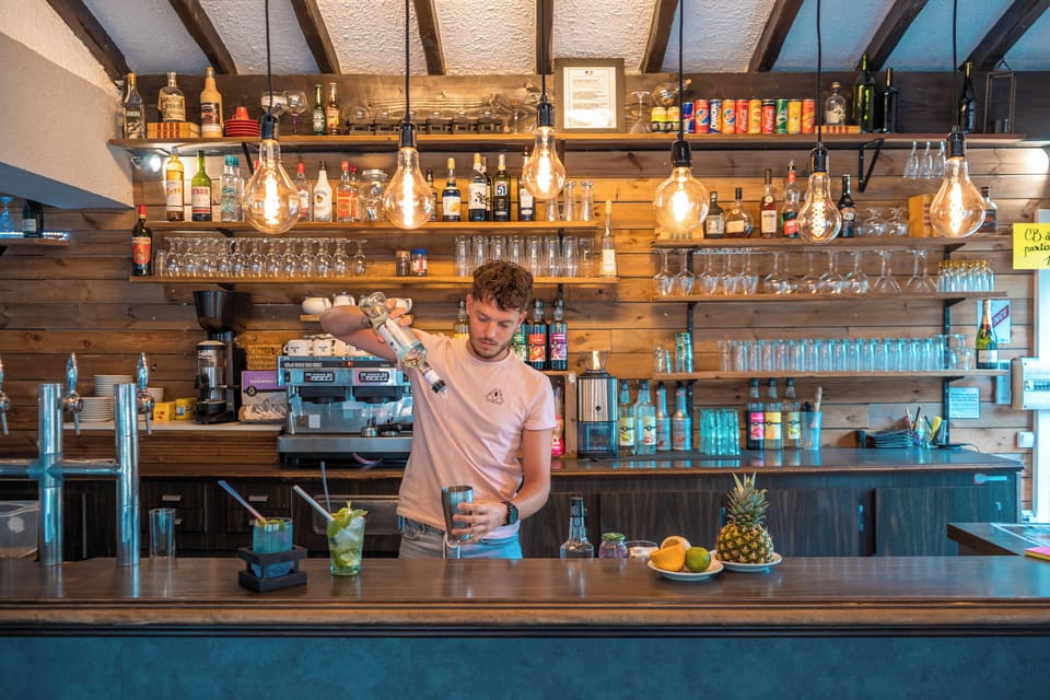Cozy bar with a rustic charm, offering refreshing drinks and a welcoming ambiance.