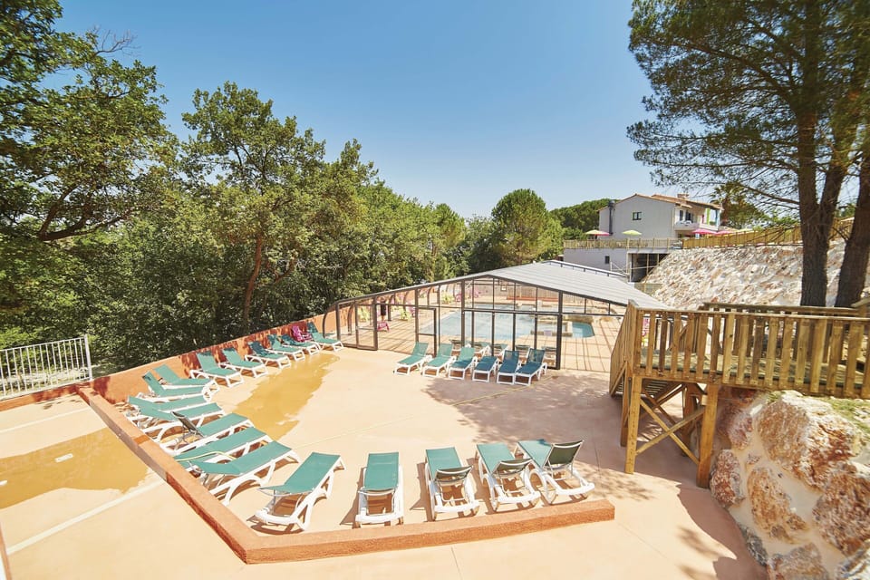 Sun-drenched terrace with plenty of loungers, perfect for relaxing poolside.