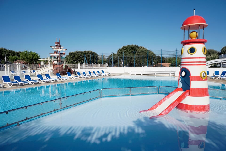 The resort’s signature lighthouse slide adds seaside charm to the family pool.