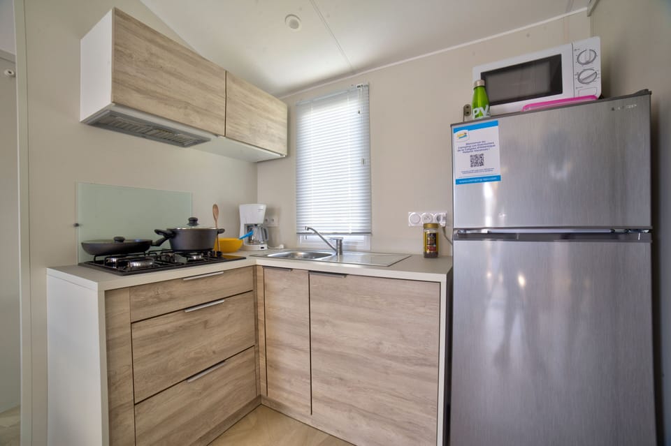 A compact, well-equipped kitchen awaits, ideal for preparing your favorite meals in a cozy, home-like setting.