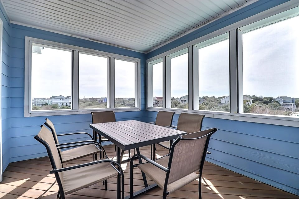 Screened-in dining area in the top level of the house.