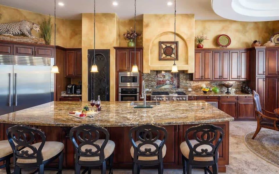 Stunning gourmet-style kitchen with stainless steel appliances, large island, breakfast table, and is fully equipped with your basic cooking essentials.
