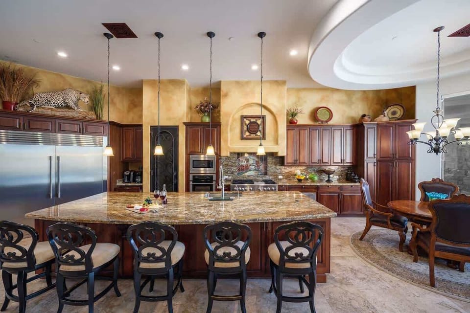 Stunning gourmet-style kitchen with stainless steel appliances, large island, breakfast table, and is fully equipped with your basic cooking essentials.