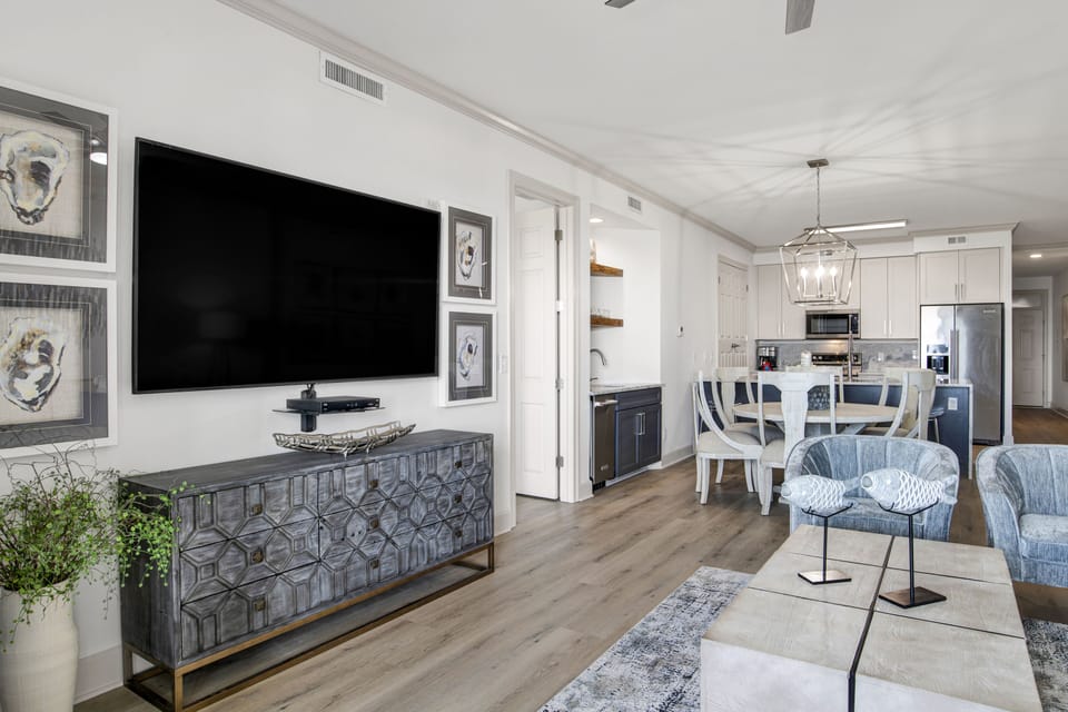 Professionally decorated living space with 75in Smart TV with streaming/cable