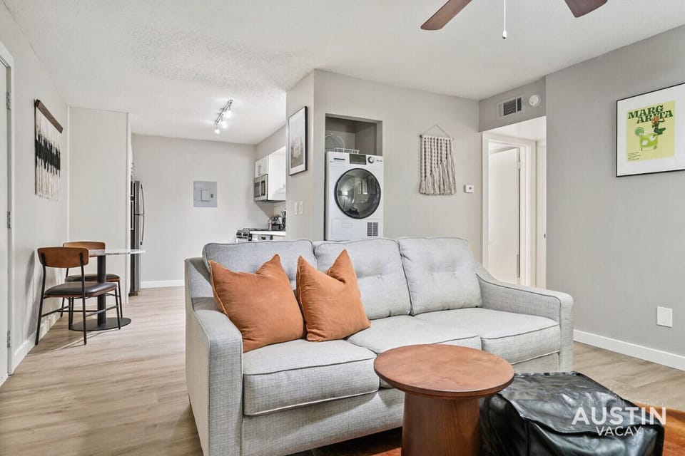 Living room with sleeper sofa, smart tv, and full length mirror