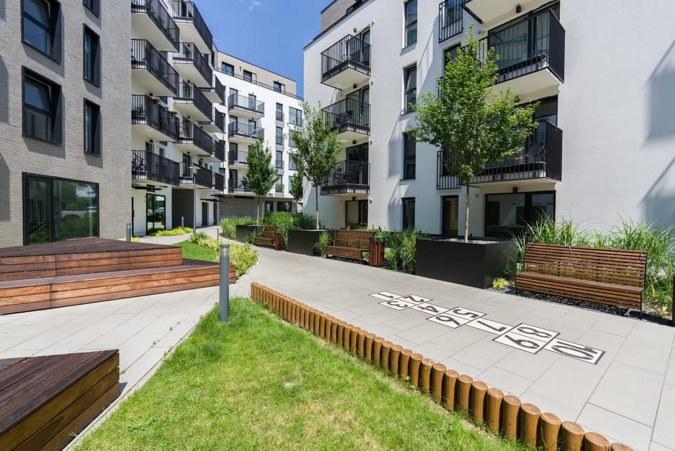 A landscaped courtyard with benches and greenery, providing a serene outdoor space for guests.
